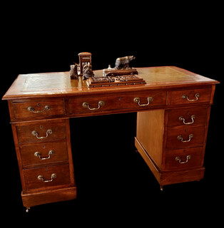 An English 19th Century Mahogany Pedestal Desk having a Green Leather.