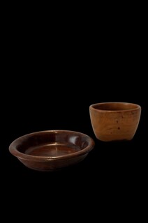 Pair of 19th century English turned wooden vessels, comprising a lignum vitae drinking cup and a treen salt cup. Fine antique treen with beautiful colour and patina.